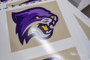Printed proof of a purple cat mascot